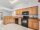 Well-equipped kitchen with black appliances and granite countertops at 1142 W Boone Ct, Lady Lake, FL 32159