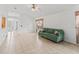 Bright living room features neutral tile floors and a comfortable green sofa at 1142 W Boone Ct, Lady Lake, FL 32159