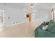 Open concept living room with tile flooring and seamless flow to the kitchen at 1142 W Boone Ct, Lady Lake, FL 32159