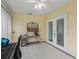 Bright sunroom featuring neutral walls, tile floors, and an exterior access door at 1142 W Boone Ct, Lady Lake, FL 32159