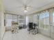 Bright sunroom with tile flooring, large windows, and ceiling fan, perfect for a home office at 1142 W Boone Ct, Lady Lake, FL 32159