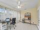 Well-lit sunroom featuring tile floors, neutral walls, and a ceiling fan for comfort at 1142 W Boone Ct, Lady Lake, FL 32159