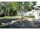 Spacious backyard with a fire pit, ideal for outdoor entertaining and relaxation under the trees at 1202 Deidrich Ct, Eustis, FL 32726