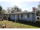 Cozy home with a manicured lawn, shaded by mature trees, offering a peaceful and inviting ambiance at 1202 Deidrich Ct, Eustis, FL 32726