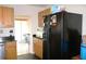 Functional kitchen with a black refrigerator and wood cabinets at 1202 Deidrich Ct, Eustis, FL 32726