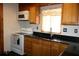 Cozy kitchen featuring wood cabinets, black countertops, and stainless steel appliances at 1202 Deidrich Ct, Eustis, FL 32726