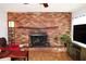 Living room features a brick fireplace and a decorative iron fire screen at 1202 Deidrich Ct, Eustis, FL 32726