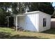 Storage shed exterior with metal siding and a small window, adjacent to a grassy area at 1202 Deidrich Ct, Eustis, FL 32726
