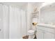 Clean bathroom featuring a shower with curtain, white cabinets, and modern fixtures at 1309 Lester Dr, Lady Lake, FL 32159