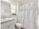 Well-lit bathroom featuring a shower with curtain and modern fixtures at 1309 Lester Dr, Lady Lake, FL 32159