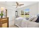 Bright bedroom featuring neutral walls, plush bedding, and a ceiling fan at 1309 Lester Dr, Lady Lake, FL 32159