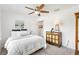 A cozy bedroom with a plush bed, decorative artwork, and a vintage cabinet at 1309 Lester Dr, Lady Lake, FL 32159