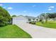 A well-maintained single-story home with an attached two-car garage and a long driveway at 1309 Lester Dr, Lady Lake, FL 32159