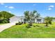 Charming single-story home with manicured lawn, lush landscaping, and a two-car garage at 1309 Lester Dr, Lady Lake, FL 32159