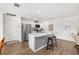 Bright kitchen featuring a stainless steel refrigerator and a cozy breakfast bar with seating at 1309 Lester Dr, Lady Lake, FL 32159