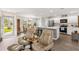 Open-concept living and dining area, flowing into the kitchen with stainless steel appliances at 1309 Lester Dr, Lady Lake, FL 32159