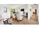 A spacious living room with neutral decor, wood floors, ceiling fan, and a comfortable seating area at 1309 Lester Dr, Lady Lake, FL 32159
