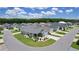 Neighborhood aerial view showing single-story homes, manicured lawns, and tree-lined streets under a bright sky at 1478 Erika Pl, The Villages, FL 32163
