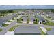 Aerial view of a well-planned neighborhood with tidy lawns, tree-lined streets, and modern single-Gathering homes at 1478 Erika Pl, The Villages, FL 32163