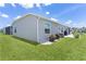 Well-maintained backyard featuring green lawn, vinyl siding, and tidy landscaping at 1478 Erika Pl, The Villages, FL 32163
