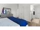 Comfortable bedroom with hard wood floors, dresser, and access to the ensuite bathroom with a view of the closet at 1478 Erika Pl, The Villages, FL 32163