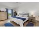 Stylish bedroom with wood floors, offering a comfortable and well-decorated space for relaxation and rest at 1478 Erika Pl, The Villages, FL 32163