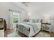 Inviting bedroom featuring a comfortable bed, soft lighting, and a peaceful ambiance with warm wood flooring at 1478 Erika Pl, The Villages, FL 32163