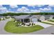 Single-story home with manicured lawn, screened porch, updated driveway, and charming landscaping at 1478 Erika Pl, The Villages, FL 32163