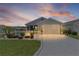 Charming home featuring an attached garage, manicured lawn, and decorative white picket fence surrounding a landscaped garden at 1478 Erika Pl, The Villages, FL 32163
