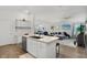 Bright kitchen with an island and sink overlooking the living room and dining area with modern countertops at 1478 Erika Pl, The Villages, FL 32163