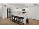 Modern kitchen featuring white cabinets, stainless steel appliances, a breakfast bar, and modern lighting fixtures at 1478 Erika Pl, The Villages, FL 32163