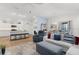 Bright living room with modern furniture, open to kitchen, and dining area bathed in natural light at 1478 Erika Pl, The Villages, FL 32163