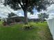 Expansive backyard showcasing fenced-in yard with screened-in pool area, mature trees and lush landscaping at 15509 Markham Dr, Clermont, FL 34714