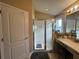 Bright bathroom featuring an enclosed glass shower and vanity area with good lighting at 15509 Markham Dr, Clermont, FL 34714