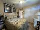 Comfortable bedroom with a well-made bed, light-colored walls, and ample closet space at 15509 Markham Dr, Clermont, FL 34714
