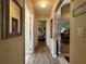 Inviting hallway with wood flooring, decorative mirrors, and archways leading to other rooms at 15509 Markham Dr, Clermont, FL 34714
