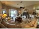 Inviting living room with comfortable seating, a ceiling fan, and sliding doors leading to the outdoor area at 15509 Markham Dr, Clermont, FL 34714