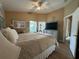 View of the spacious main bedroom featuring natural light, neutral decor, and wood-look flooring at 15509 Markham Dr, Clermont, FL 34714