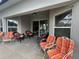 Outdoor patio with several chairs and sliding glass door leading to the home's interior at 15509 Markham Dr, Clermont, FL 34714