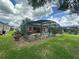 Backyard view highlighting the screened-in pool area with a large pool and outdoor seating at 15509 Markham Dr, Clermont, FL 34714