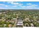 Aerial view of colorful townhomes surrounded by lush greenery and a sunny blue sky at 1603 Woodward St # 18, Orlando, FL 32803