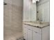 Bathroom featuring walk-in shower, granite vanity, and white cabinets at 1603 Woodward St # 18, Orlando, FL 32803