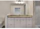 Bathroom featuring white vanity with stone countertop and shower with marble tiling at 1603 Woodward St # 18, Orlando, FL 32803