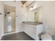 Modern bathroom with double granite vanity, walk-in shower, and sleek fixtures at 1603 Woodward St # 18, Orlando, FL 32803