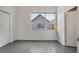 Bright bedroom with concrete floors, neutral walls, and a window at 1603 Woodward St # 18, Orlando, FL 32803
