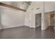 Bedroom with white walls, painted concrete floors, and an open doorway to the bathroom at 1603 Woodward St # 18, Orlando, FL 32803