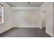 Spacious bedroom with concrete floors, neutral walls, and an inviting open doorway at 1603 Woodward St # 18, Orlando, FL 32803