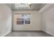 Modern bedroom with neutral walls, concrete floors, and a large window at 1603 Woodward St # 18, Orlando, FL 32803