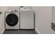 Laundry room featuring side-by-side, white, front-loading Samsung washer and dryer at 1603 Woodward St # 18, Orlando, FL 32803