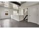Open living space with exposed metal ceiling, modern staircase, and neutral walls at 1603 Woodward St # 18, Orlando, FL 32803